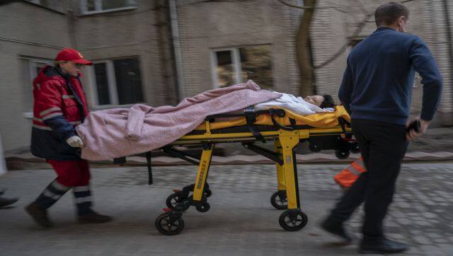 An injured woman is wheeled on a stretcher at a local hospital in Novoiavorisk, western Ukraine. Waves of Russian missiles pounded a military training base close to Ukraine's western border with NATO member Poland. AP