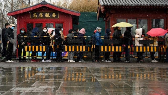 People queue to get a swab test for the COVID-19 coronavirus in Beijing. AFP