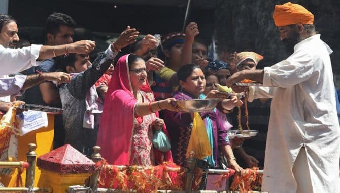 Kashmiri Pandits offer alms at the Mata Kheer Bhawani Temple during its annual festival in the village of Tullamulla near Srinagar. Hundreds of Kashmiri Hindus attend the festival to worship the Hindu goddess every year. AFP