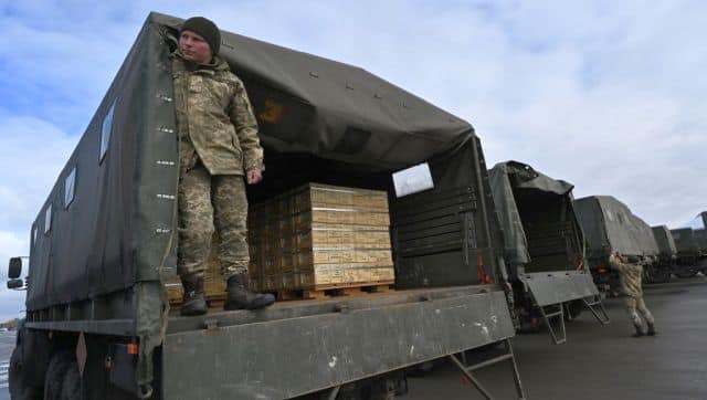 Servicemen of Ukrainian Military Forces Employees load trucks with US military aid at Kyiv's Boryspil airport. AFP