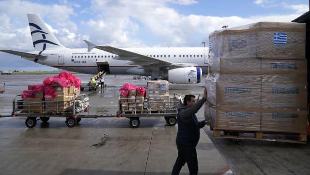 Workers of the airport and Greek armed forces personnel prepare a plane loaded with humanitarian aid at Eleftherios Venizelos International Airport in Athens. The plane, bound for Poland, was being sent after Greece's government decided to provide aid to Ukraine. AP