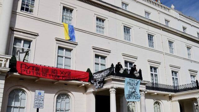 A group of squatters display banners and a Ukrainian national flag on the facade of a mansion supposedly belonging to Russian oligarch Oleg Deripaska in Belgrave Square, central London. AFP