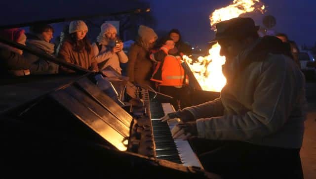 German Pianist Davide Martello performs 'We are the Champion's at Medyka, Poland. AP