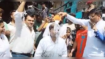 Delhi: AAP councillor jumps into sewage to clean it, gets milk bath later