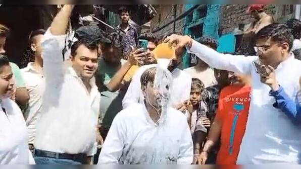 Delhi: AAP councillor jumps into sewage to clean it, gets milk bath later