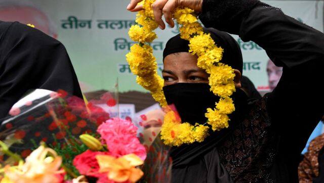 File image of a Muslim woman holding a garland of flowers to celebrate the passage of a law to outlaw Triple Talaq. AFP