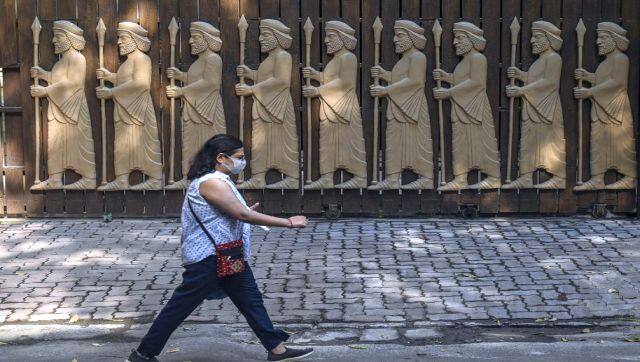 A woman walks past walks past a fire temple in Mumbai. AFP
