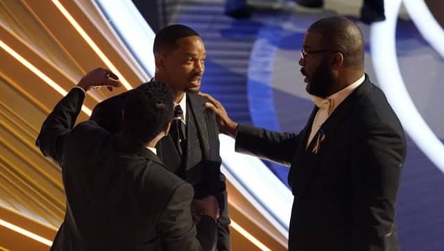 Sean Combs, from left, Will Smith and Tyler Perry appear in the audience at the Oscars on Sunday, March 27, 2022, at the Dolby Theatre in Los Angeles. (AP Photo/Chris Pizzello)