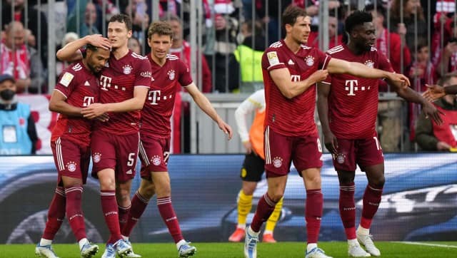 Bayern players celebrate after Bayern's Robert Lewandowski scoring his side's second goal during the German Bundesliga soccer match between Bayern Munich and Borussia Dortmund, at the Allianz Arena, in Munich, Germany, Saturday, April 23, 2022. (AP Photo/Matthias Schrader)