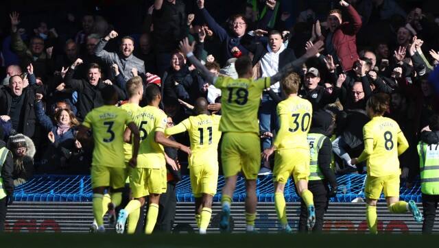 Brentford's Yoane Wissa celebrates with his teammates after scoring his side's fourth goal during the English Premier League soccer match between Chelsea and Brentford, at the Stamford Bridge stadium in London, Saturday, April 2, 2022. (AP Photo/Ian Walton)