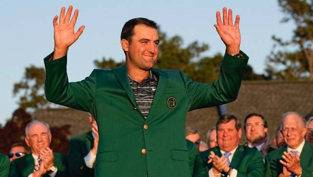 Scottie Scheffler celebrates after putting on the green jacket after winning the 86th Masters golf tournament on Sunday, April 10, 2022, in Augusta, Ga. (AP Photo/David J. Phillip)