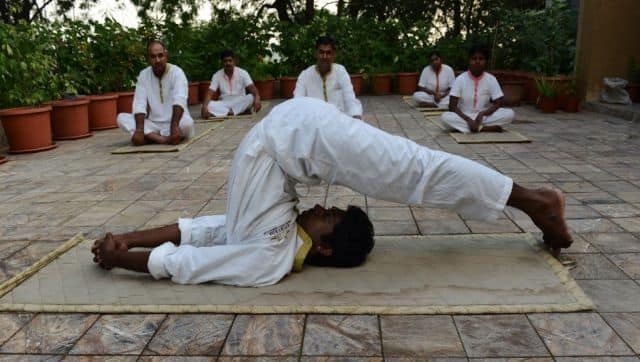 An Indian ayurvedic therapist demonstrates yoga in the Dev Dholera village near Ahmedabad. AFP
