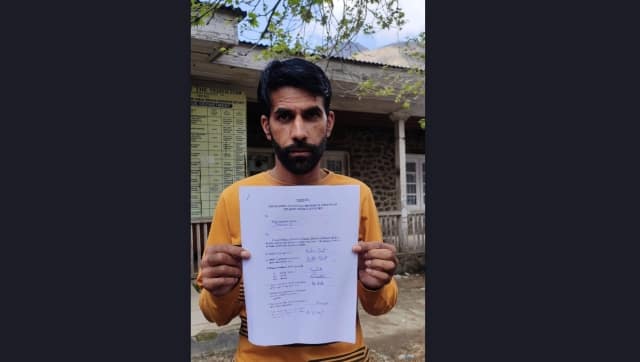 Bashir Ahmad Bhat displaying his PSP documents. Image by Idrees Bukhtiyar