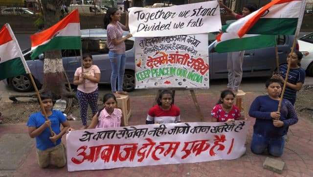 Students of an art school hold Indian flags and placards appealing people to maintain communal harmony after recent incidents of communal clashes in many parts of the country, in Mumbai. AP