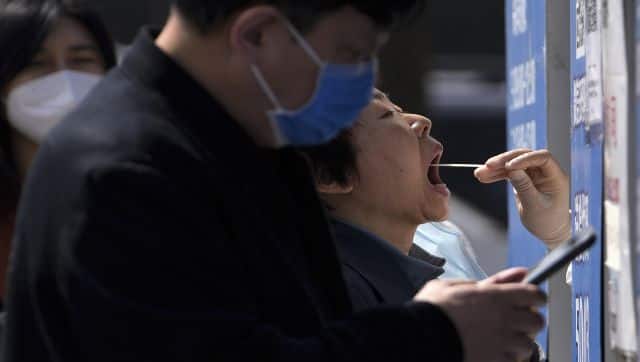 China reported over 20,000 Covid-19 cases on Wednesday, the highest daily tally since the start of the pandemic. AP