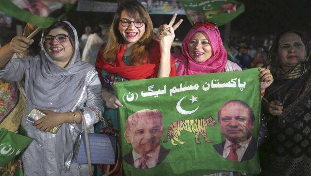 Supporters of newly elected Pakistani prime minister Shahbaz Sharif flash victory signs to celebrate outside their party's office, in Lahore, Pakistan. AP