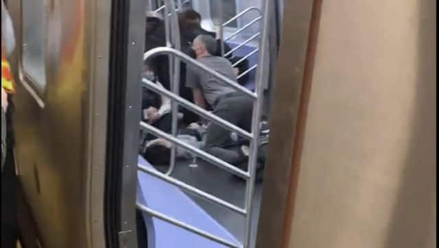 A person is aided in a subway car in the Brooklyn borough of New York, Tuesday after the shooting. More than 20 people have been injured. Will B Wylde via AP
