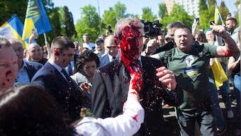 Russian envoy to Poland hit with red paint at war cemetery on Victory Day
