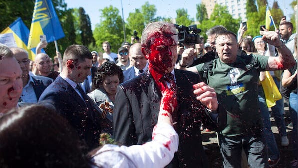 Russian envoy to Poland hit with red paint at war cemetery on Victory Day