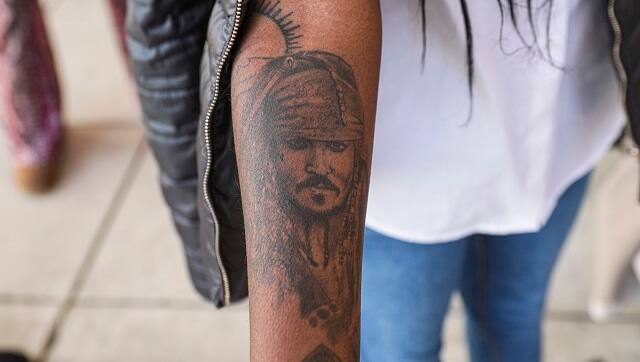 Teresa Lima shows a tattoo of Johnny Depp on her arm in Fairfax, Virginia, April 27, 2022. Lima, a fan of the actor, traveled from Portugal to attend the trial between Depp and his ex-wife Amber Heard. (Valerie Plesch/The New York Times)