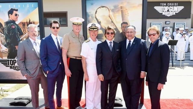 Pictured (L-R): Christopher McQuarrie, Joseph Kosinski, Lt. General Mark Wise, Deputy Commandant for Aviation of the United States Marine Corps, Vice Admiral Kenneth R. Whitesell, Commander, Naval Air Forces, Tom Cruise, Carlos Del Toro, Secretary of the Navy and Jerry Bruckheimer | Image Credit: AFP