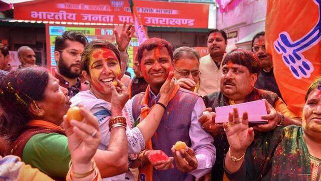 BJP supporters celebrate with colour after the party’s win in Uttarakhand Assembly polls, at BJP state office, in Dehradun on 10 March, 2022. PTI