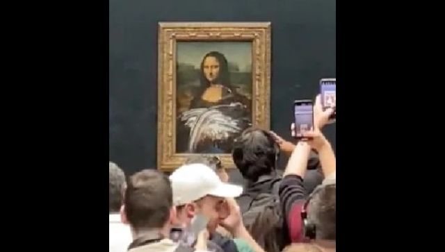 Mona Lisa artwork in Paris smeared with cake by man in disguise, watch video Mona Lisa artwork in Paris smeared with cake by man in disguise, watch video