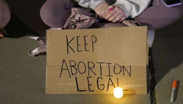 A crowd of people gather outside the Supreme Court in Washington. A draft opinion circulated among Supreme Court justices suggests that earlier this year a majority of them had thrown support behind overturning the 1973 case Roe v Wade that legalised abortion nationwide, according to a report published Monday night in Politico. AP