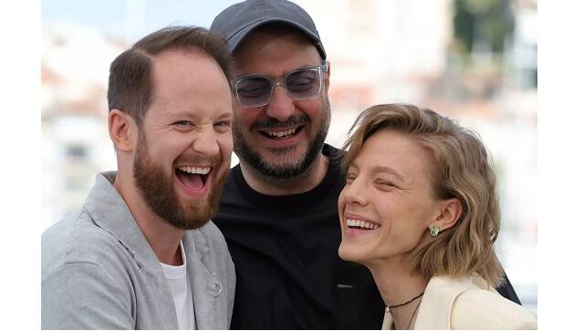 Serebrennikov and his two leading actors in ‘Tchaikovsky’s Wife’, Odin Biron and Alyona Mikhailova, share a laugh in Cannes | Valery HACHE AFP