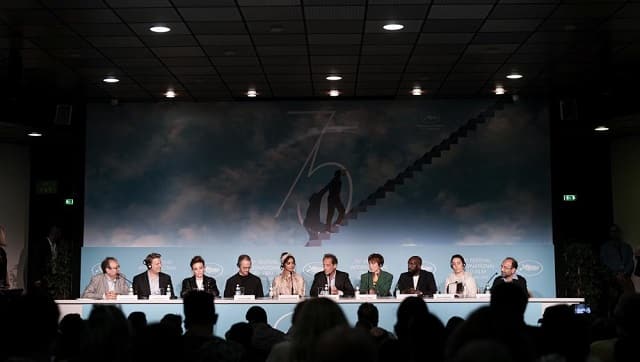 Didier Allouch, from left, jury members Jeff Nichols, Jasmine Trinca, Joachim Trier, Deepika Padukone, jury president Vincent Lindon, jury members Rebecca Hall, and Asghar Farhadi speak at the press conference for the jury at the 75th international film festival, Cannes, southern France, Tuesday, May 17, 2022. (AP Photo/Petros Giannakouris)