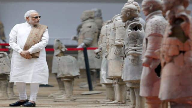 Prime Minister Narendra Modi takes a look at sculptures of the Terracotta Army, a World Heritage Site, in the city of Xian in northwest China's Shaanxi province. AFP