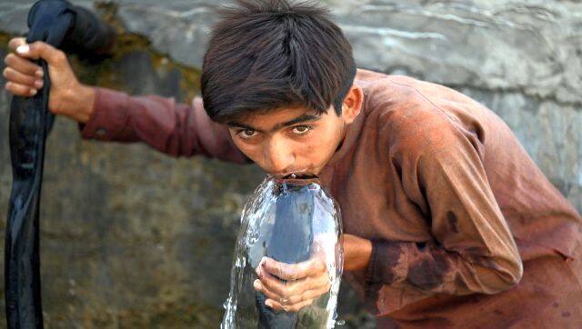 A boy drinks water from a pipe at the water supply plant during heatwave in Jacobabad, in southern Sindh province, Pakistan. AFP