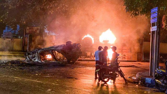 A vehicle belonging to the security personnel and a bus set alight near Mahinda Rajapaksa's official residence in Colombo. AFP
