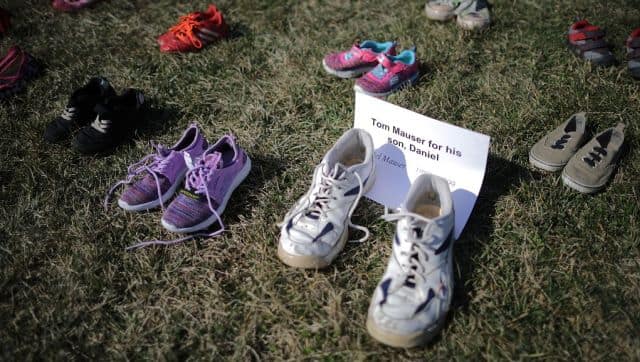 Seven thousand pairs of shoes, representing the children killed by gun violence since the mass shooting at Sandy Hook Elementary School in 2012, are spread out on the lawn on the east side of the US Capitol in March 2018 in Washington, DC. AFP