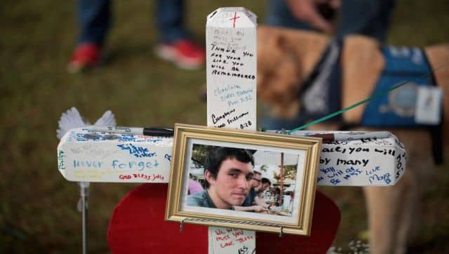 A photo of Christian Garcia hangs on a cross at a memorial in front of Santa Fe High School. The makeshift memorial honoured the victims of the attack on the school in May 2018. AFP