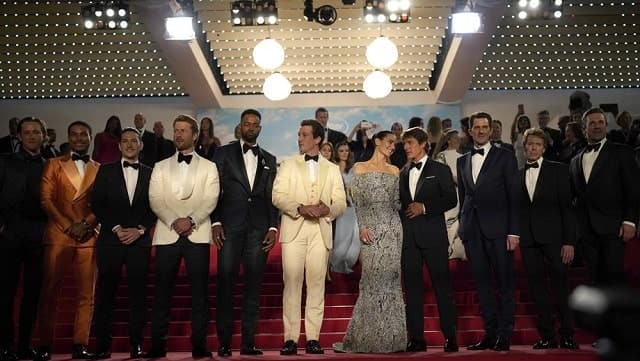 Lewis Pullman, from left, Greg Tarzan Davis, Danny Ramirez, Glen Powell, Jay Ellis, Miles Teller, Jennifer Connelly, Tom Cruise, director Joseph Kosinski, Jerry Bruckheimer, and Jon Hamm depart after the premiere of the film ‘Top Gun: Maverick’ at the 75th international film festival, Cannes, southern France, Wednesday, May 18, 2022. (AP Photo/Daniel Cole)