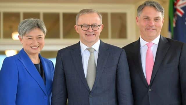 Australia's new Prime Minister Anthony Albanese poses with his new cabinet ministers, Penny Wong (left) and Richard Marles after the oath taking ceremony at Government House in Canberra. AFP
