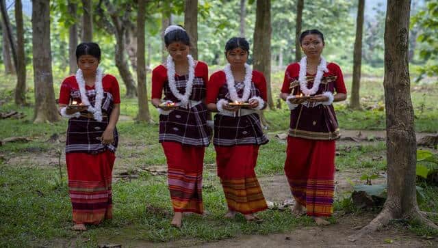 Indian Rabha tribal girls in traditional attire bring offerings before they perform a tribal Rabha dance during Baikho festival at Gamerimura village along the Assam Meghalaya border, west of Gauhati, India. Every year, the community in India’s northeastern state of Assam celebrates the festival, to please a deity of wealth and ask for good rains and a good harvest. AP