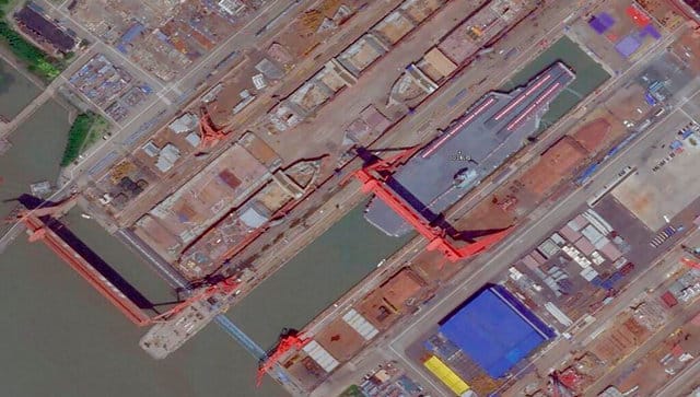 This satellite image from Planet Labs PBC shows China's new Type 003 aircraft carrier with bunting on its desk preparing to be launched Wednesday, June 15, 2022, from a shipyard in Shanghai, China. China on Friday, June 17, 2022, launched its third aircraft carrier, the first such ship to be designed and built entirely within the country. (Planet Labs PBC via AP)