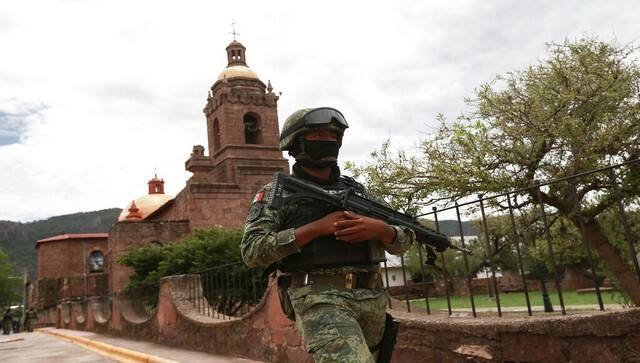 A Mexican soldier patrols outside the Church in Cerocahui, Mexico. AP
