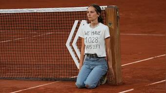Watch: French Open semi-final halted as climate activist ties herself to net