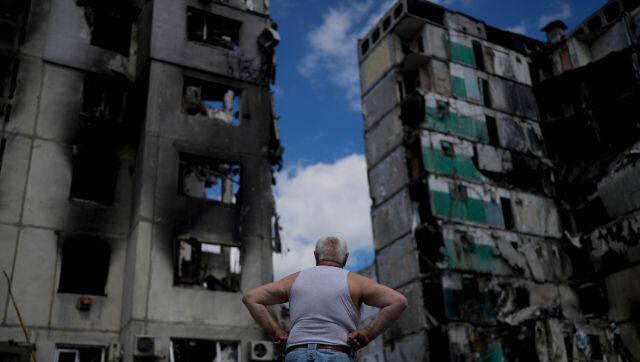 A man stands looking at a building destroyed during attacks, in Borodyanka, on the outskirts of Kyiv, Ukraine. AP