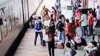 Watch|Woman falls while trying to board moving train, RPF personnel averts tragedy