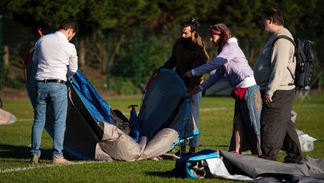 People fold up their tent after camping overnight in the queue before the start of day one of the Wimbledon tennis championships in London, Monday, June 27, 2022. (Aaron Chown/PA via AP)