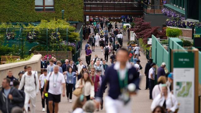 Spectators arrive at the courts on day one of the Wimbledon tennis championships in London, Monday, June 27, 2022. (AP Photo/Alberto Pezzali)