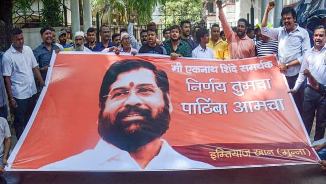 Supporters of Shiv Sena leader Eknath Shinde shout slogans outside his residence in Thane. PTI 