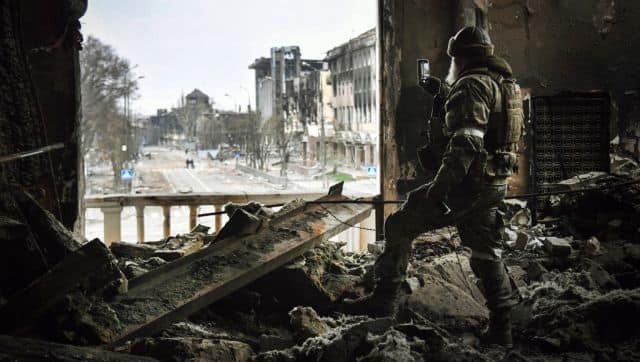 A Russian soldier patrols the Mariupol drama theatre, bombed last 16 March. AFP