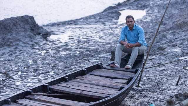 Ratan Jana, 33 years old, tourist guide, Dulki village is on a local fishing boat. Image courtesy Polina Schapova