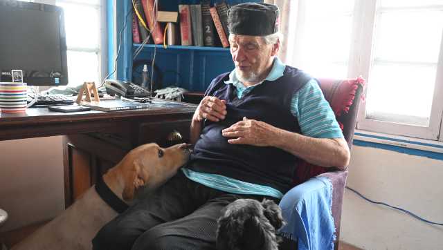 Author Bill Aitken at his Landur residence with his dogs Frida and Freddie. Image courtesy Shail Desai