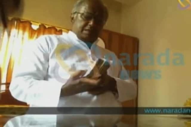 A TV grab of TMC leader Sougata Roy allegedly taking cash in Narada sting video. News18 File